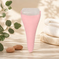 Pink ice roller in a relaxing spa scene with eucalyptus